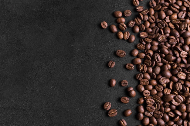 Minimalist black background and arrangement of coffee beans