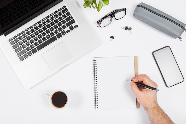 Minimalist business arrangement on white background with man taking notes