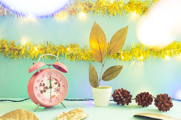 Minimalist concept idea displaying products. christmas and new year backgrounds. alarm clock. pine flower