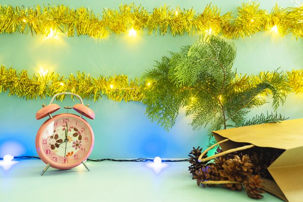 Minimalist concept idea displaying products. christmas and new year backgrounds. alarm clock. pine flower