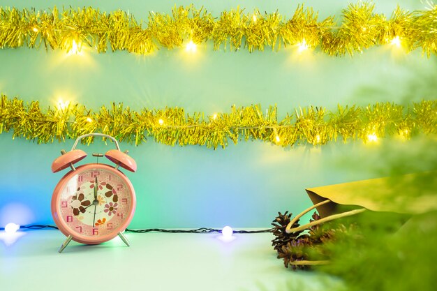 Minimalist concept idea displaying products. christmas and new year backgrounds. alarm clock. pine flower