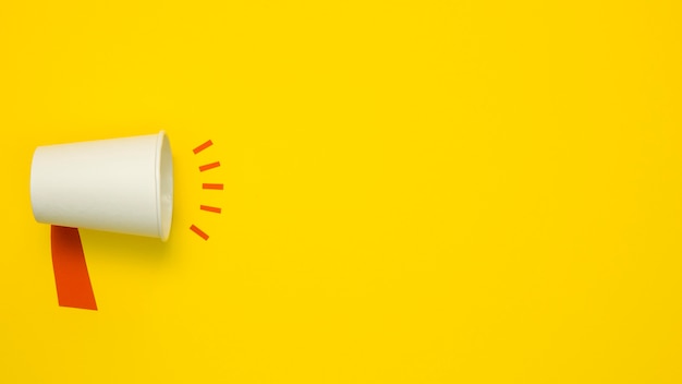 Photo minimalist concept with megaphone on yellow background