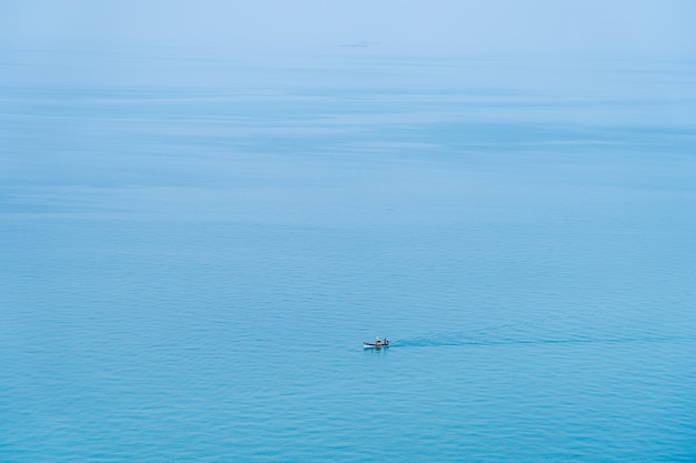 Minimalist fishing boat in the sea ocean.