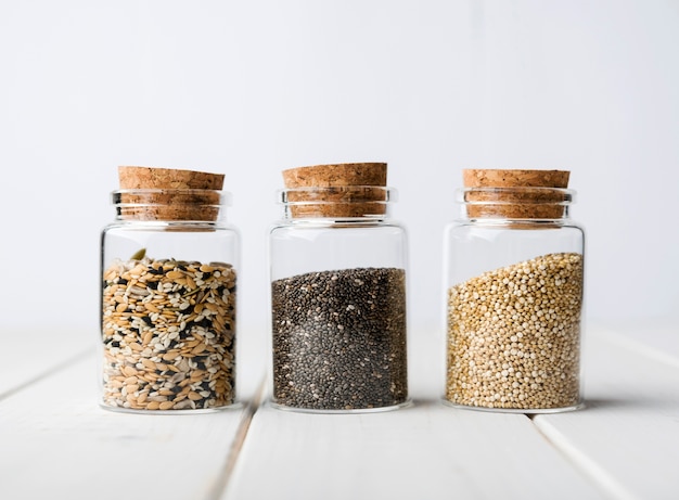 Photo minimalist jars filled with crushed seeds