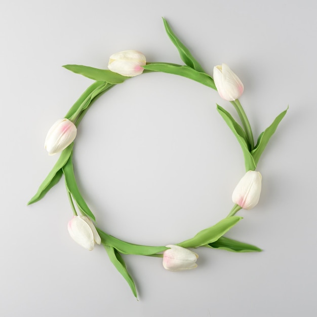 Minimalist layout of flowers on a gray background Creative floral wreath of tulips Top viewxDxA