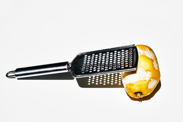 Minimalist photo of a lemon scratched with the scratcher. White background