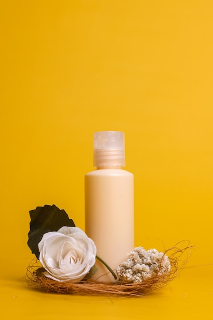 Minimalist summer style of showcase for cosmetics product display on yellow background with flowers