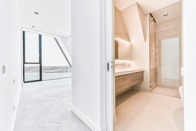 Minimalist wooden cabinet with double washbasins and wall mount faucets under glowing mirror