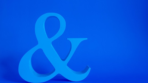 Minimalistic blue ampersand on blue background