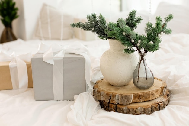 Minimalistic Christmas composition with fir branches in a modern ceramic vase Front view Copy space