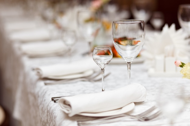 Minimalistic image of glasses for alcoholic beverages on a table set for celebration