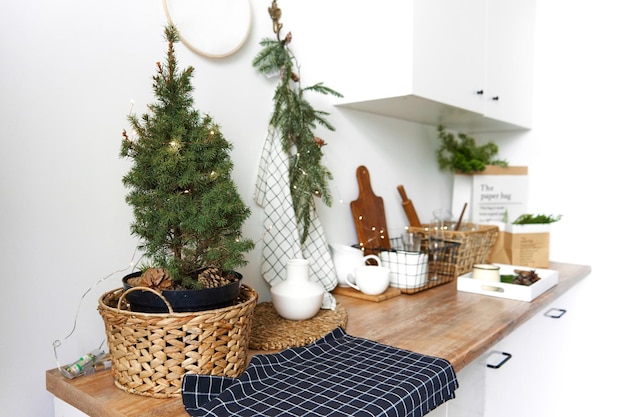 Minimalistic light kitchen interior using pine branches