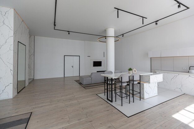 Minimalistic modern luxury design of an expensive house with marble trim on a sunny day white walls with plaster parquet decorative lighting and no one inside