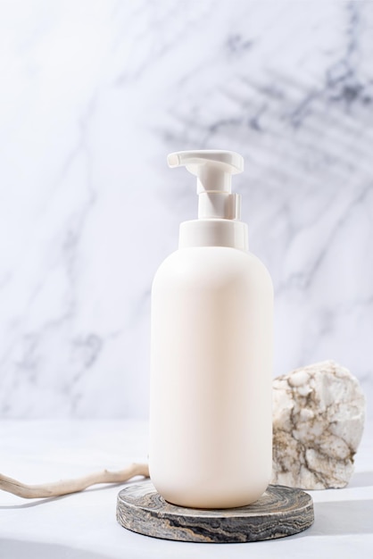 A minimalistic scene of a podium and white dispenser bottle\
with stones on white background for natural cosmetics