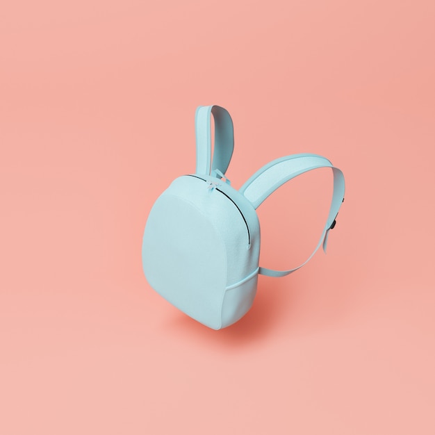 minimalistic scene of a small blue school bag floating on a red pastel background