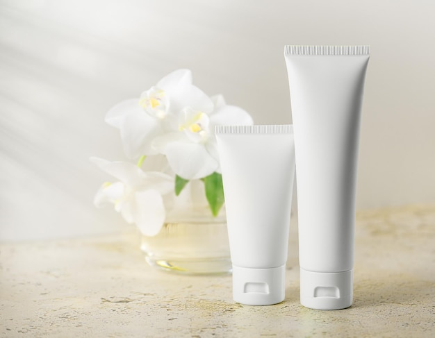 minimalistic white tubes on light background skincare or cosmetic product mockup
