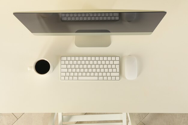 Minimalistisch werkruimteconcept met desktopcomputer op witte tafel