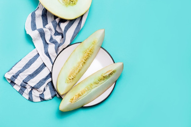 Minimum flat lay of fresh melons sliced on a pastel blue background with copy space. healthy food concept