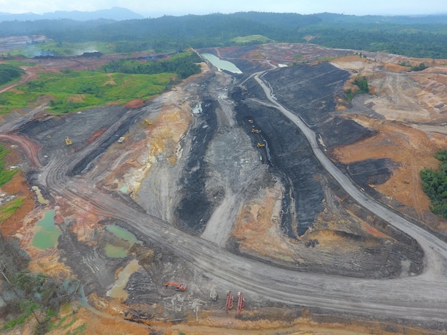 mining activities, coal getting, hauling and loading at a coal mining Project. Aerial view.