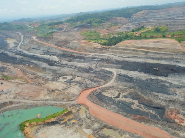 mining activities, coal getting, hauling and loading at a coal mining Project. Aerial view.