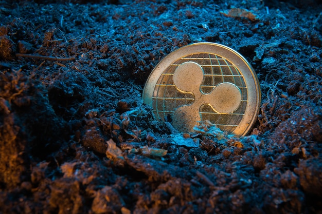 Mining crypto currency - Ripple coin, online money coin in the dirt ground.