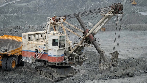 Mining excavator scooping up ore in a quarry close up of limestone mining