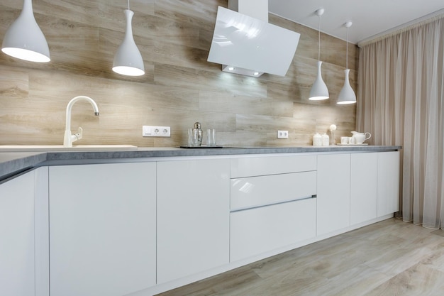 MINSK BELARUS AUGUST 2020 Interior of the modern luxure kitchen in studio apartments in minimalistic style with light color