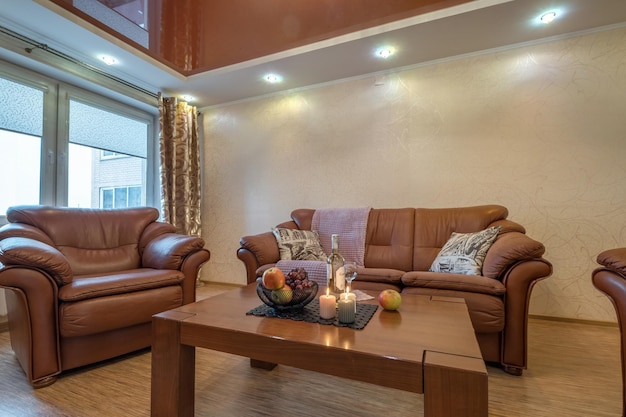 Minsk belarus august 2021 big sofa in interior the modern\
living room with tv table and candles