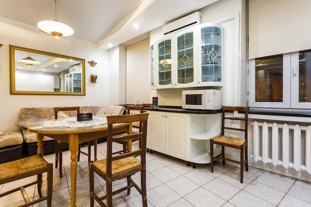 MINSK BELARUS DECEMBER 8 2017 Interior of the modern kitchen and guest hall in loft flat in light color style