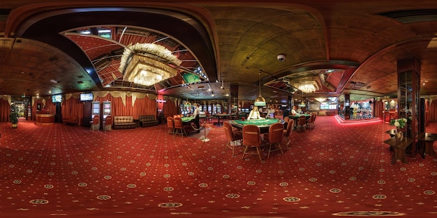 Minsk belarus february 2017 panorama 360 angle view in interior\
elite luxury casino with croupiers girls in red style full 360\
degree seamless panorama in equirectangular spherical\
projection