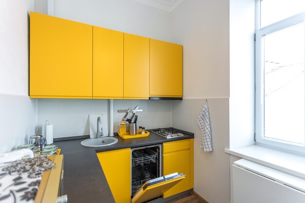 MINSK BELARUS JANUARY 2019 Interior of the modern kitchen in loft flat apartment in minimalistic style with yellow color