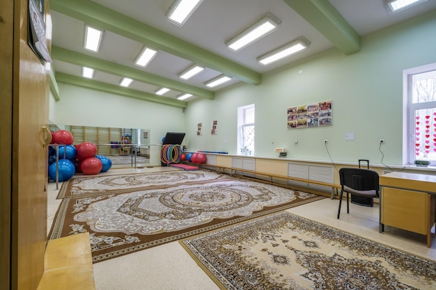 MINSK BELARUS JULY 2019 interior of stylish fitness club for kids gymnastics room with sports simulators