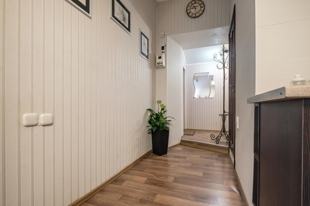 MINSK BELARUS JULY 2021 long corridor in interior of entrance hall of modern apartments with doors cabinets shelves and a mirror