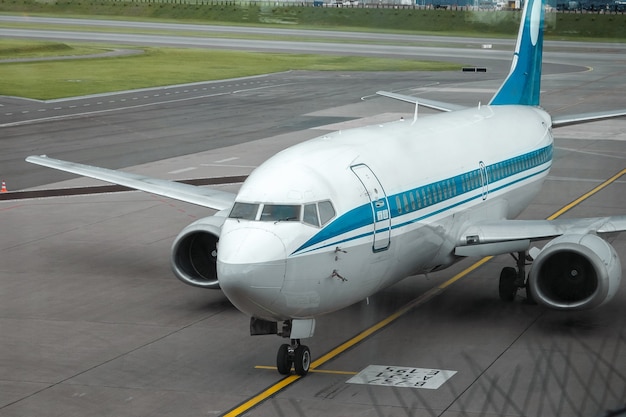 MINSK, BELARUS - JUNE 16, 2021 Minsk International Airport. The view from the window dwindled to the runway and airplanes. International passenger transportation.