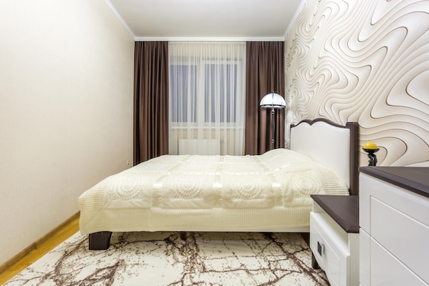 MINSK BELARUS JUNE 2020 Double bed with pillows in interior of the modern intimate bedroom in flat in light color style apartments