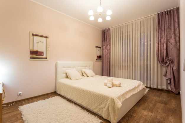 Minsk belarus june 2020 double bed with pillows in interior of
the modern intimate bedroom in flat in light color style
apartments