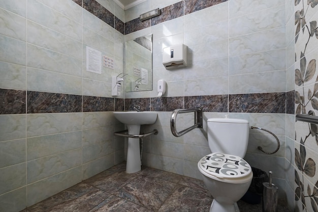 MINSK BELARUS MARCH 2020 water tap sink with faucet in small bathroom detail of a corner shower cabin with wall mount shower attachment in cheap hotel