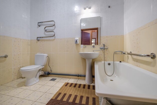 Minsk belarus march 2020 water tap sink with faucet in small
bathroom detail of a corner shower cabin with wall mount shower
attachment in cheap hotel