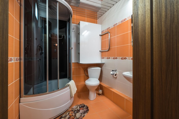 MINSK BELARUS MARCH 2020 water tap sink with faucet in small bathroom detail of a corner shower cabin with wall mount shower attachment in cheap hotel