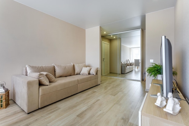 MINSK BELARUS MAY 2020 Interior of the modern guestroom in studio apartments with sofa served table and tv