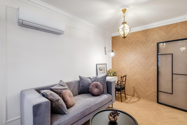 Minsk belarus may 2020 interior of modern living room with tv\
sofa and working place in studio apartments in light color\
style