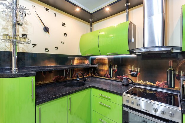 MINSK BELARUS MAY 2020 Interior of the modern luxure kitchen with guest table in studio apartments in minimalistic style with green color