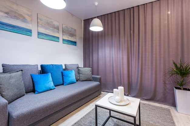 Minsk belarus september 2019 interior of the modern guestroom
in studio apartments with sofa and blue pillows