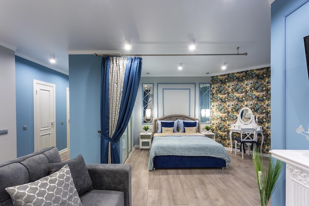 MINSK BELARUS SEPTEMBER 2019 Interior of the modern luxure bedroom in studio apartments in blue light color style