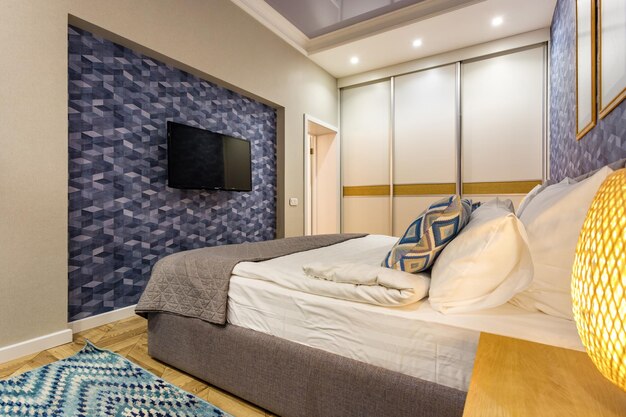 MINSK BELARUS SEPTEMBER 2019 Interior of the modern luxure vip bedroom with big double bed in studio apartments