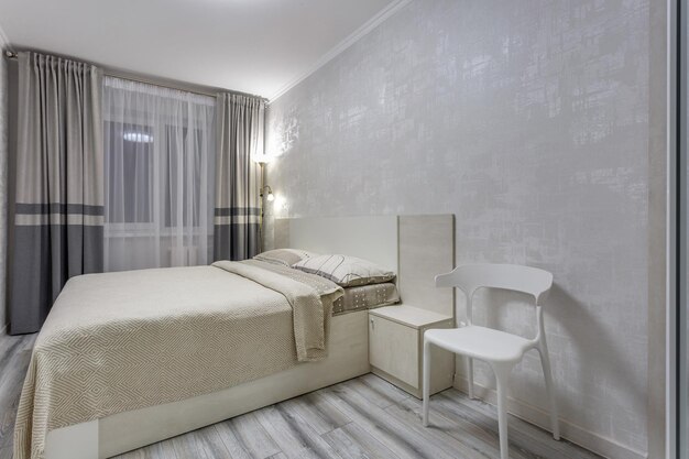 MINSK BELARUS SEPTEMBER 2020 Interior of the modern luxure bedroom in studio apartments in light color style