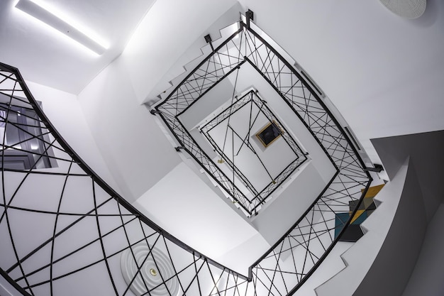 Minsk belarus september 2020 white stairs emergency and\
evacuation exit spiral stair in up ladder in a new office\
building
