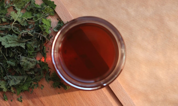 Mint leaf syrup in a glass jar with dry mint leaves