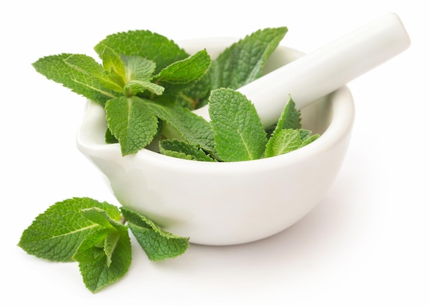 Mint leaves in a mortar with pestle