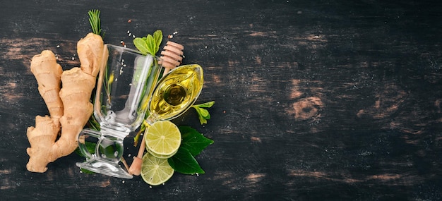 Photo mint, lime, ginger and lemon. on a wooden background. top view. copy space.